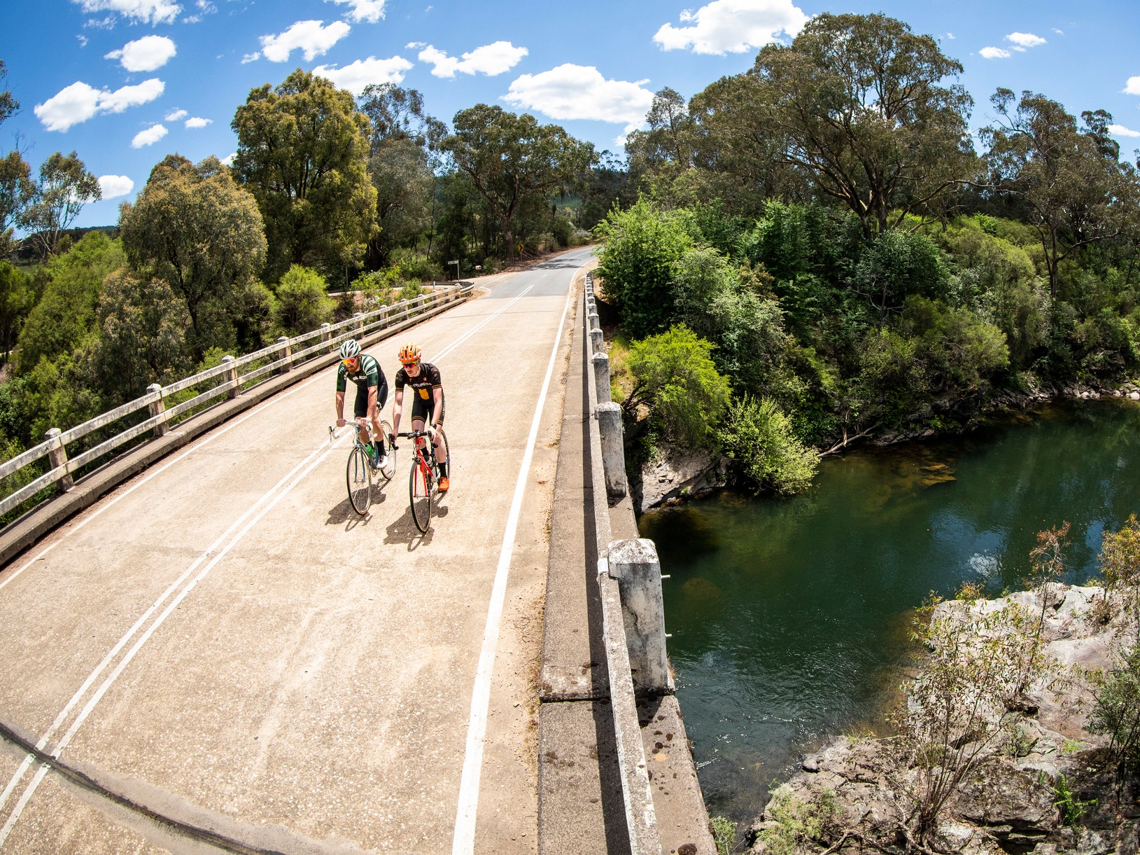 Cyclists riding over a bridge to Lake Buffalo